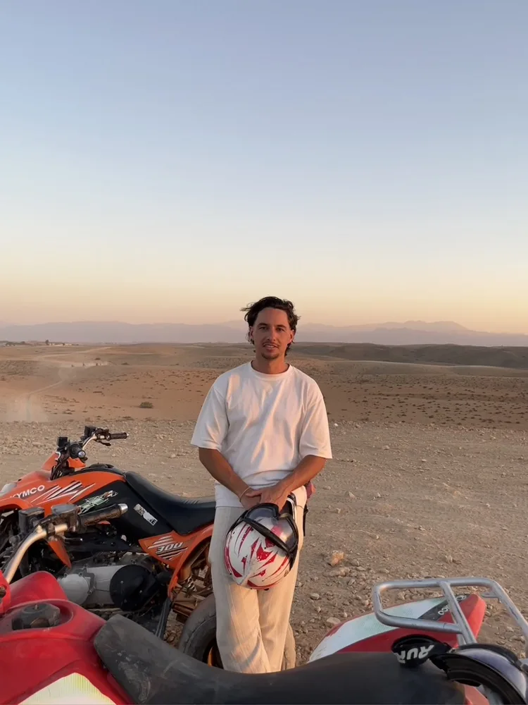 Jack in the desert next to a quad bike at sunset