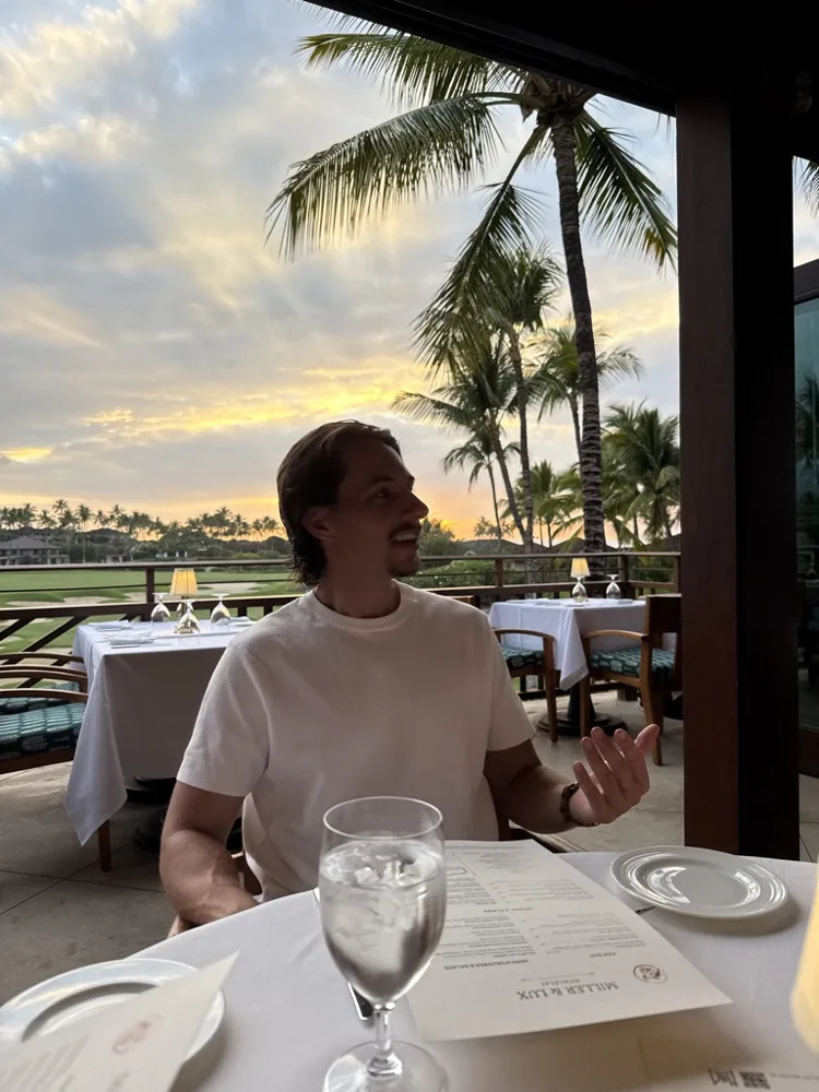 Jack at dinner by the beach under palm trees