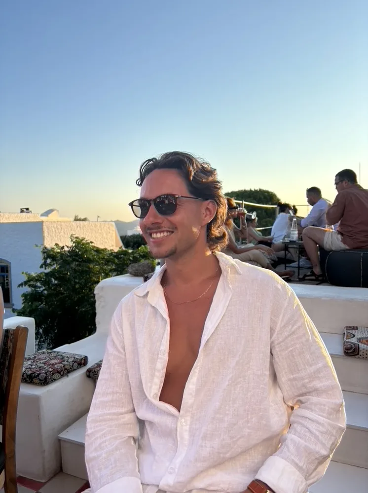 Jack in sunglasses at sunset by the water